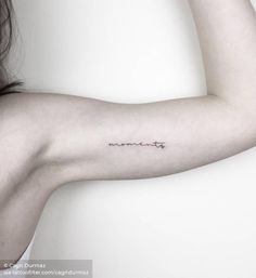 a woman's arm with the word love tattooed on her left arm and an arrow in the middle