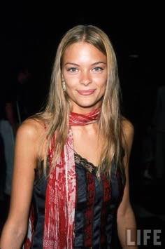 a beautiful young woman wearing a red scarf