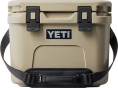 a tan yeti cooler with black straps and the words yeti on it's side