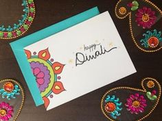 a colorful card with the words happy diwali written on it and decorated with flowers