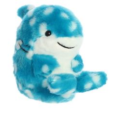 a blue and white stuffed animal sitting on top of it's back legs in the air