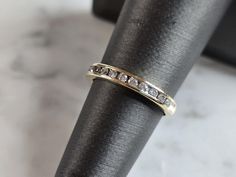 a gold ring with three diamonds on it