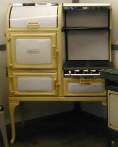 an old fashioned stove with two ovens next to it