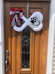 the front door is decorated with an animal themed bow