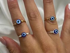 please note you will need to size up from your original ring size as the bands on my rings are on the thicker side  Save when you shop through my website, I'd appreciate it 💚- https://shorturl.at/dGU49 Wire wrapped evil eye ring! Lovingly handmade with so much love & positive intention!  ✨check out the rest of my jewellery here - https://etsy.me/3nxyN99 ✨ Wear a stunning Evil Eye ring for protection, luck & good fortune 💓✨.  The evil eye is and has been a powerful symbol for spiritual protecti Evil Eye Open Ring As Gift, Adjustable Evil Eye Open Ring Jewelry, Spiritual Blue Rings With Evil Eye Detail, Gold Evil Eye Jewelry, Symbolic Evil Eye Ring Jewelry, Blue Eye Ring, Spiritual Blue Evil Eye Ring, Eye Ring Silver, Eye Rings