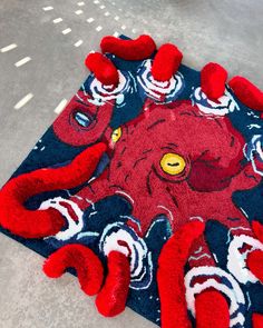 a red rug with an octopus on it