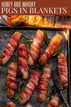 Cooked Pigs in blankets on a baking tray next to a bottle of whiskey. Pork Chipolatas, Pigs In Blankets, British Christmas, Cocktail Sausages, Christmas Sides, Christmas Cake Recipes, Pigs In A Blanket, Honey Glaze, Holiday Feast