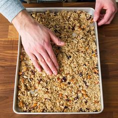 a person reaching for some food in a pan