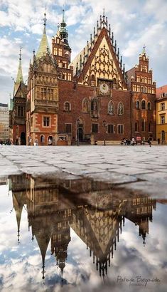 an old building with many spires is reflected in the water