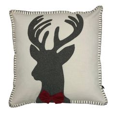 a deer pillow with a red bow tie on it's head and antlers