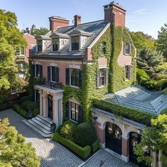 this is an aerial view of a large house with ivy growing on it's roof