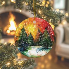 a christmas ornament hanging from a tree in front of a fireplace with lights