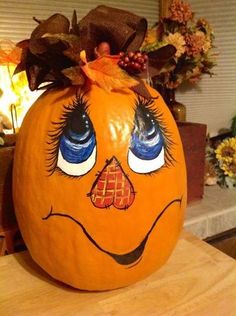 a pumpkin with eyes painted on it sitting on a table