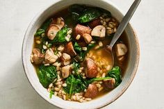 a bowl of soup with mushrooms and spinach