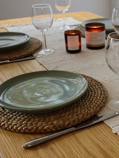 the table is set with wine glasses and plates