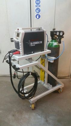 a machine that is sitting on top of a cart with a hose attached to it