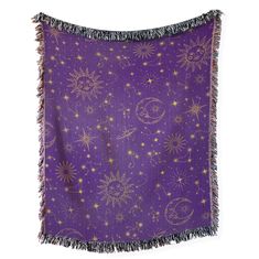 a purple blanket with gold stars and moon designs on it, against a white background