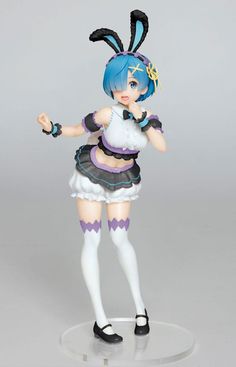 an anime figurine is posed on a clear base with black and white hair