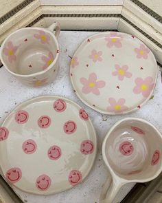 three dishes with flower designs on them are sitting on the floor next to each other