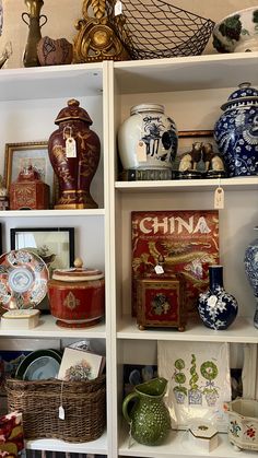 shelves filled with vases and other decorative items in china style decorating the room