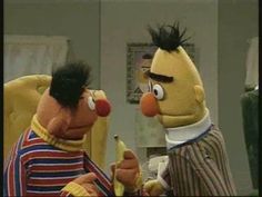 two puppets are talking to each other in front of a mirror with one holding a banana