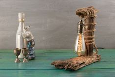 two glass bottles and a wooden stick on a green table with rope wrapped around them