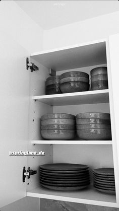 black and white photograph of dishes on shelves