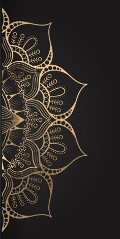 a black and gold wallpaper with an intricate design on the back ground, in front of a dark background