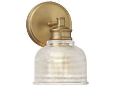 an antique brass finish wall light with clear glass shade