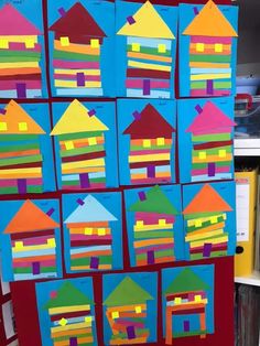 colorful houses made out of construction paper on a bulletin board