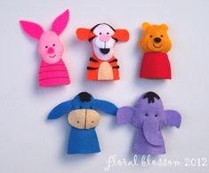 four felt animal puppets are arranged in the shape of children's heads and hands