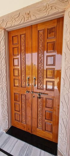 a wooden door with intricate carvings on the sides and side panels inlayed to it