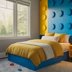 a yellow and blue bed in a bedroom next to a window with the moon phases on it