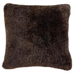 a dark brown pillow with fluffy fur on the front and back of it's sides