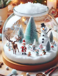 a snow globe filled with christmas decorations on top of a table next to other items