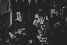 black and white photograph of two men playing guitars