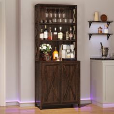 a tall wooden cabinet filled with bottles and glasses