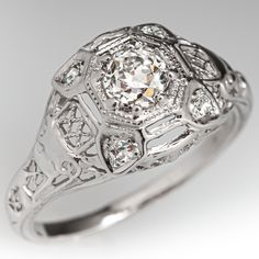 an antique style diamond ring with filigrees