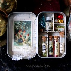 an open tin box filled with spices and condiments on top of a table