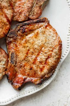 grilled steaks on a white plate