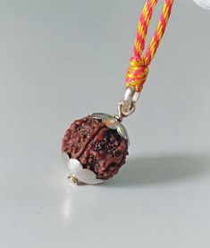 Sterling silver Rudraksha necklace . lord Shiva pendant necklace. This beaded necklace can be worn by men, women, girls, boys,  Beads size 19×21mm approximately Beads material :-Rudraksha Item weight :-5.740 gm  colorful cotton soft string :- 1 Necklace length :- 15"- 30" inches adjustable   925 sterling silver cap necklace  Rudraksha Acts as a protective shield for the body Radiates special energy that has a positive effect on the body, mind, and soul Mitigates negative karma Improves concentration Balances the chakras and removes potential illnesses As the jewelry is made by hand, each item is unique and may vary slightly in size and color to those photographed here. *Buyer note-The buyer is fully responsible for any charges, import, caution, duties and taxes in buyer country. Traditional Silver Mala As A Gift, Silver Beads Temple Necklace Gift, Adjustable Pendant Necklace For Puja, Traditional Silver Mala As Gift, Silver Mala As Festival Gift, Silver Mala For Festival Gifts, Silver Temple Necklace With Round Beads As Gift, Silver Temple Jewelry Mala As Gift, Spiritual Necklaces With Silver Beads For Puja