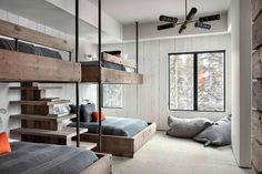 a bedroom with bunk beds and pillows on the floor