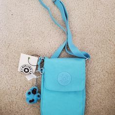 Kipling K12131 Tissy Blue Splash Tonal Purse Bag Wallet Shoulder Bag Size Measurements: 18x13 Cm All Parts Included In This Auction Are Authentic. This Item Comes From A Pet And Smoke Free Home! Please Feel Free To Ask Me Any Questions! Blue Phone Bag With Removable Pouch For Daily Use, Portable Blue Satchel Shoulder Bag, Portable Blue Travel Pouch, Portable Light Blue Pouch Bag, Trendy Blue Shoulder Bag, Blue Travel Phone Pouch Bag, Blue Travel Pouch Phone Bag, Blue Pouch Bag For Mobile Phone, Blue Bags With Mobile Phone Pocket For Everyday Use