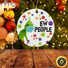 an ornament with the words ew people on it hanging from a christmas tree