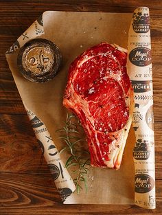 a piece of meat sitting on top of a wooden cutting board