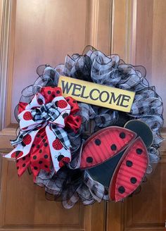 a ladybug door hanger with a welcome sign and two shoes on it