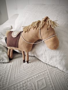 a stuffed horse laying on top of a pillow