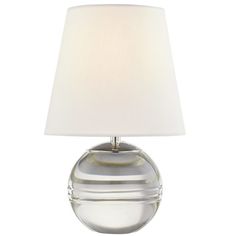 a glass table lamp with a white shade on it's base and a light bulb in the middle