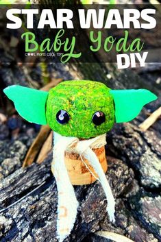 a star wars baby yoda toy sitting on top of a tree stump with the title overlay