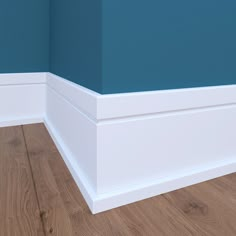 the corner of a room with blue walls and wood flooring is painted teal